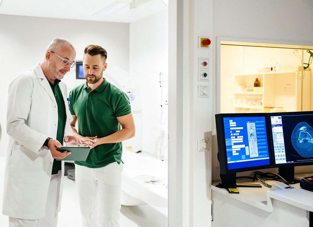  A clinician in a lab coat explains a file to a patient.