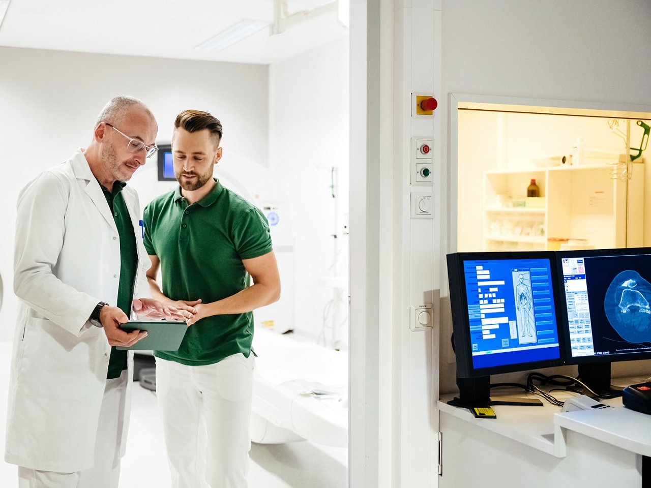 A clinician in a lab coat explaining a file to a patient