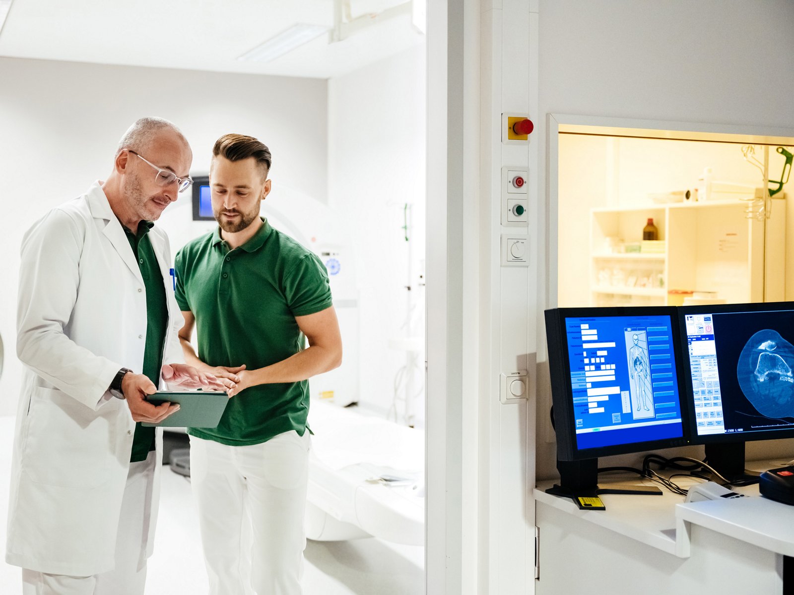 A clinician in a lab coat explaining a file to a patient