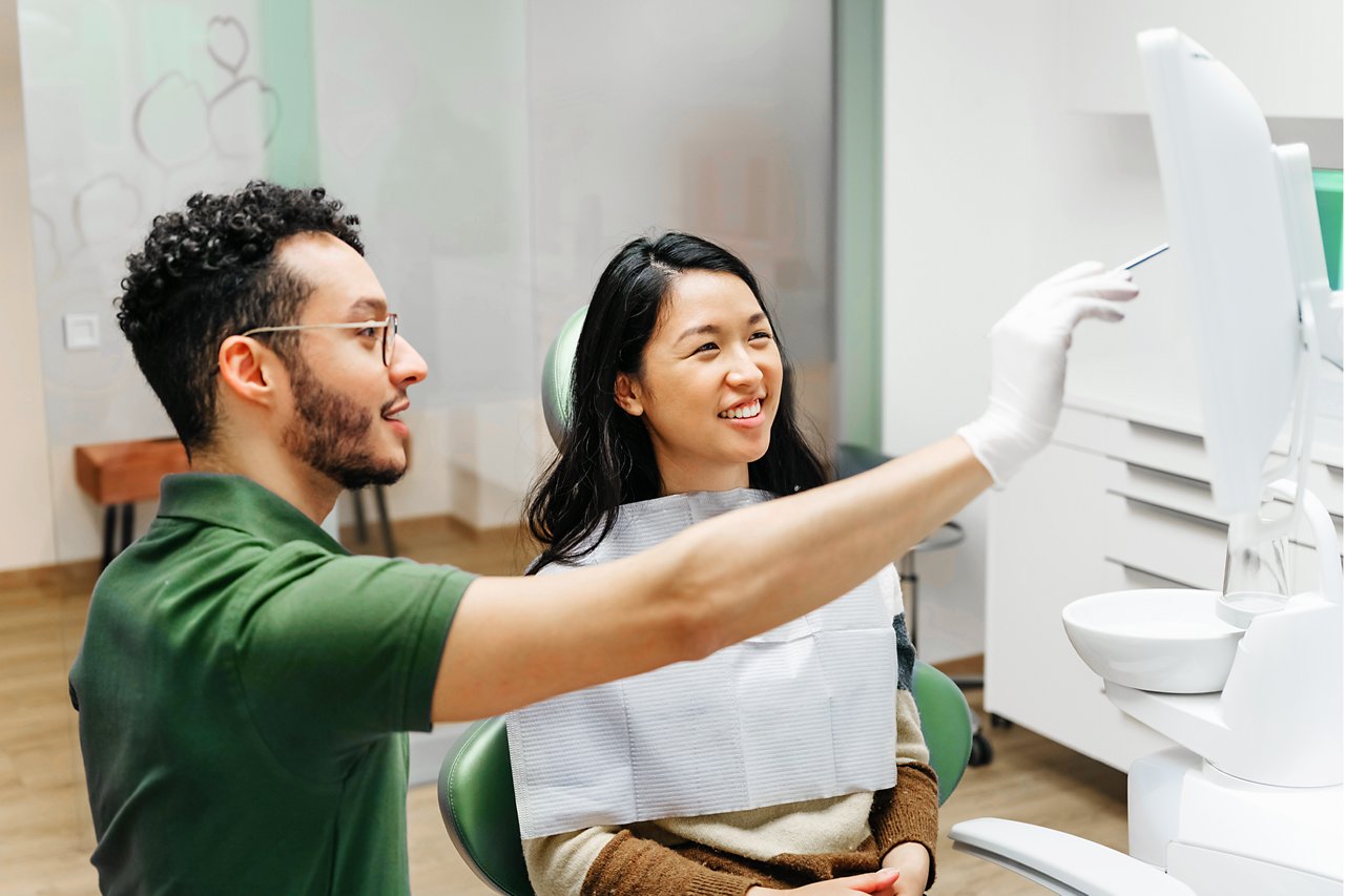 Young patient talking to dentist about dental health during check-up, Berlin, Germany