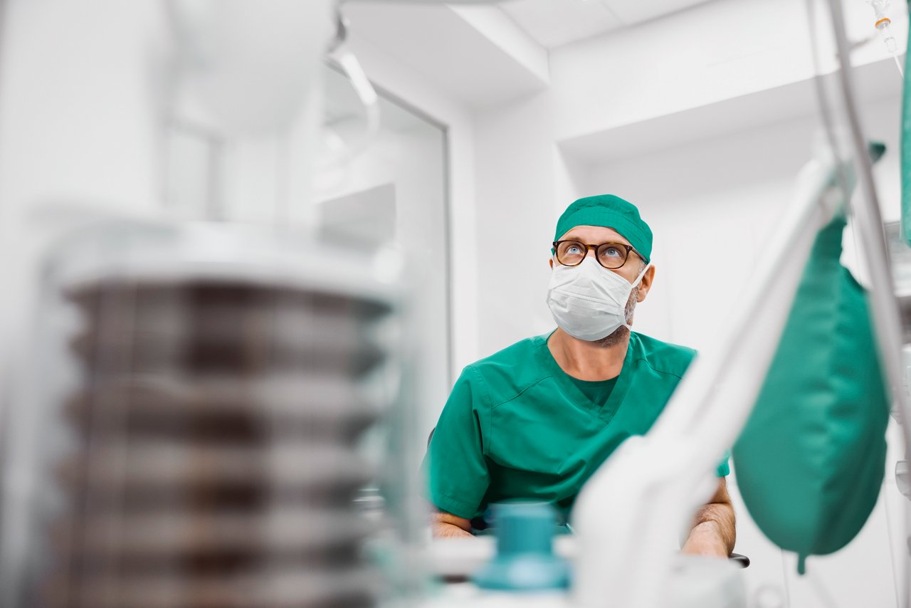 Male anesthesiogist during surgery in an operating room