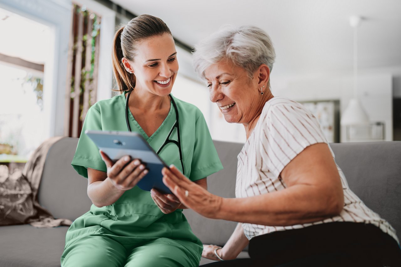 Nurse and patient viewing content on a tablet