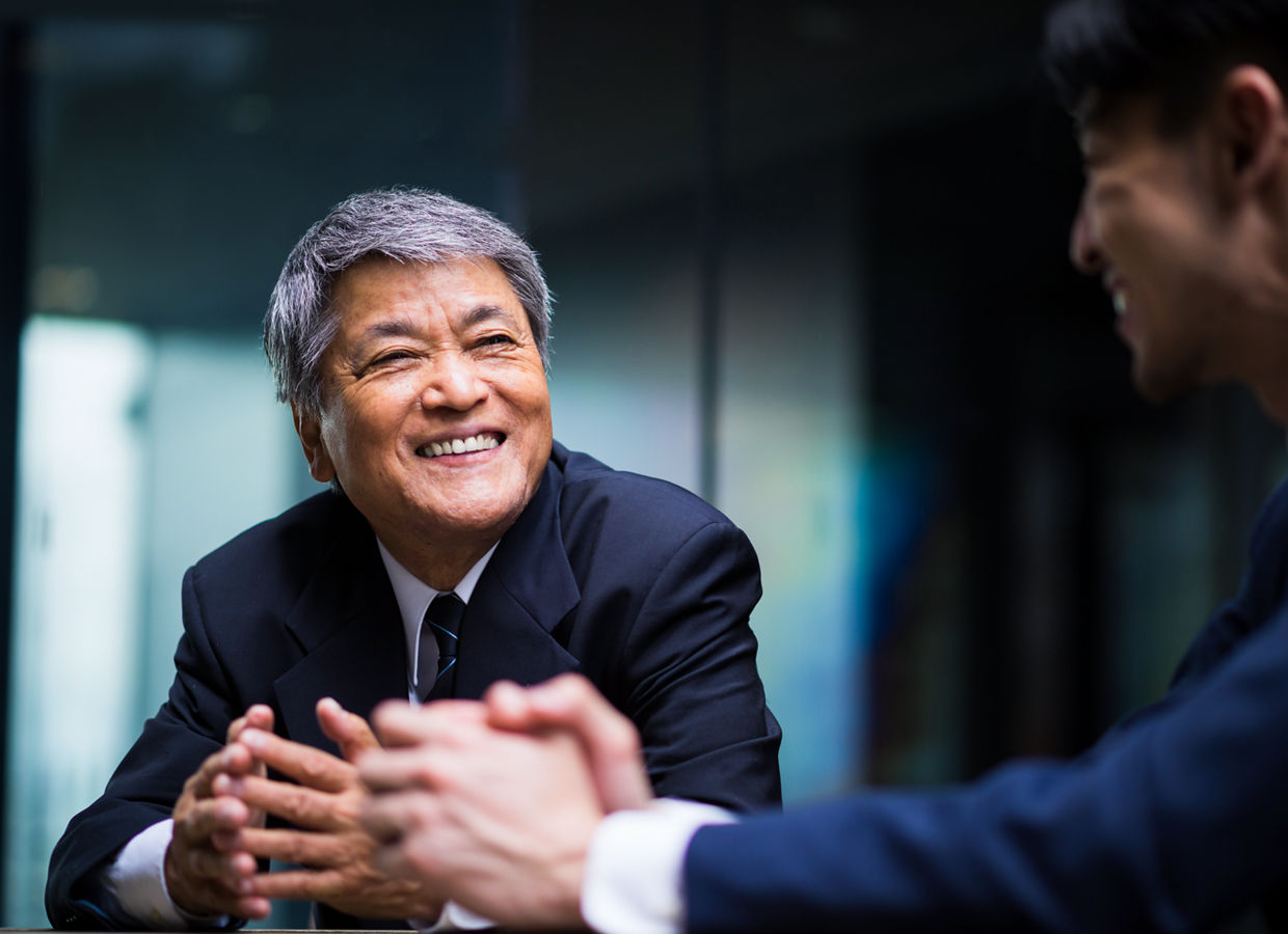 Two business professionals interacting in an office.