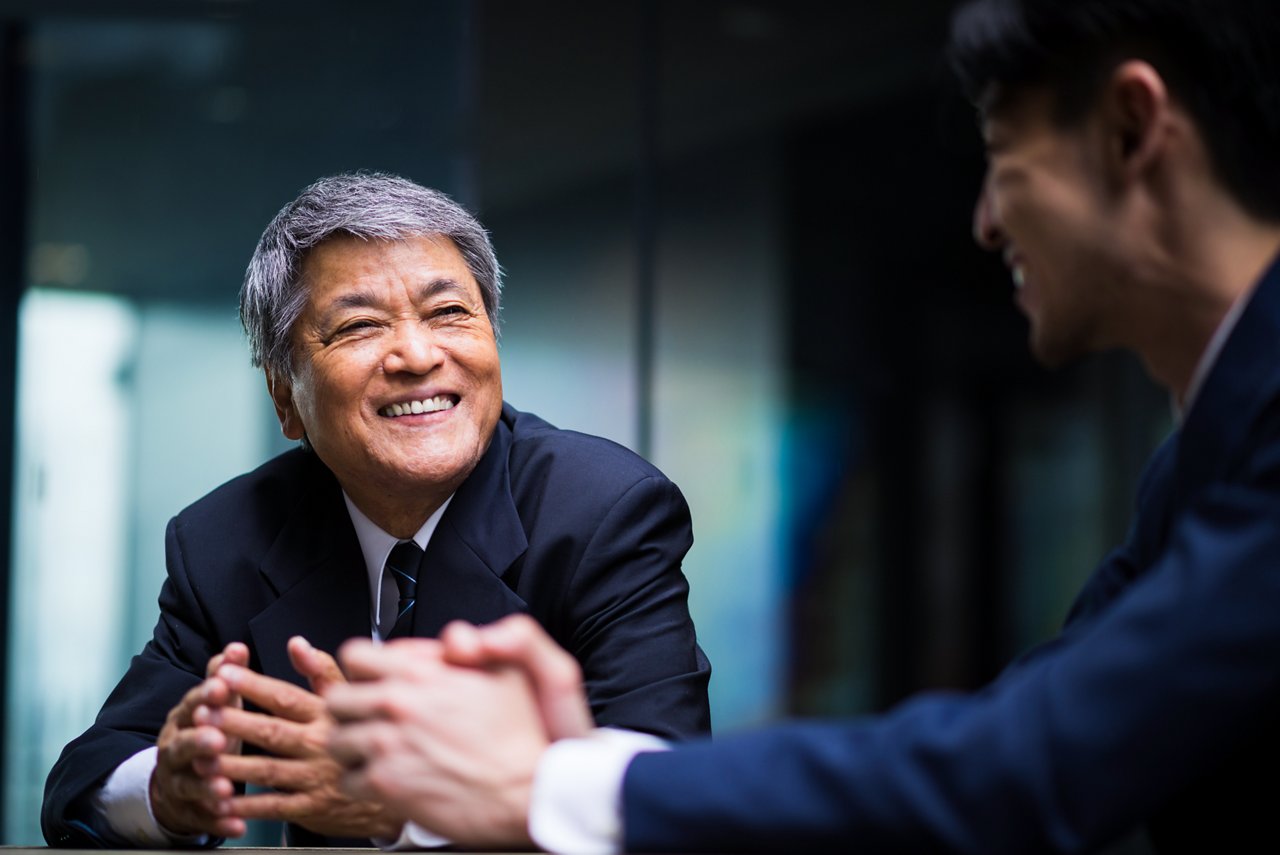 Two business professionals interacting in an office.