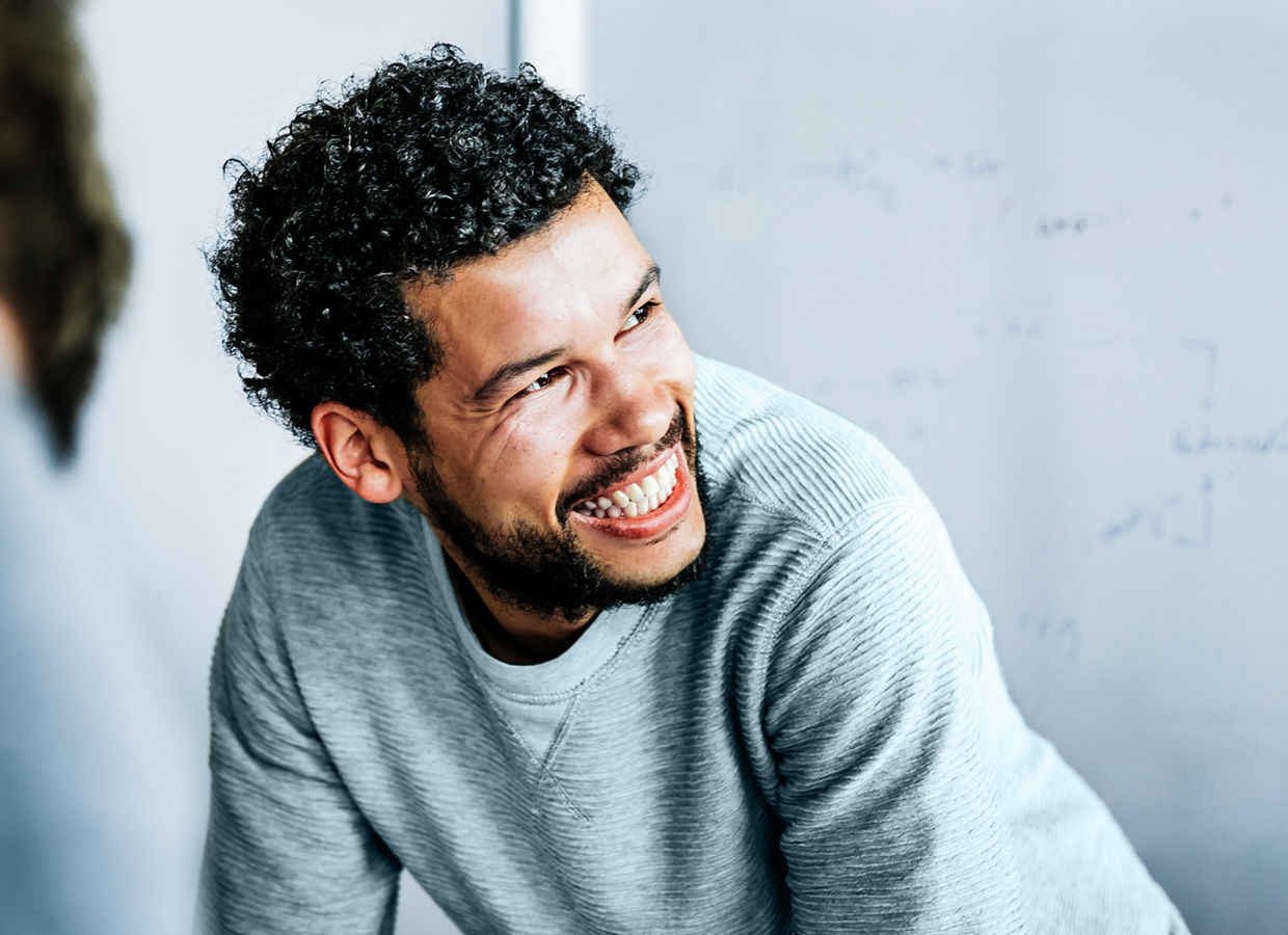 Man in casual clothing interacting in a conference room.