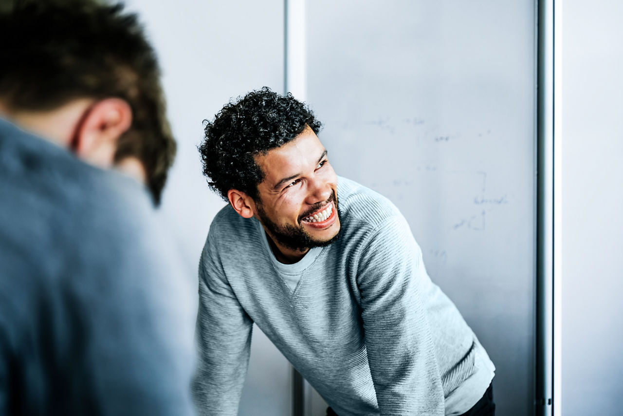 Man in casual clothing interacting in a conference room.