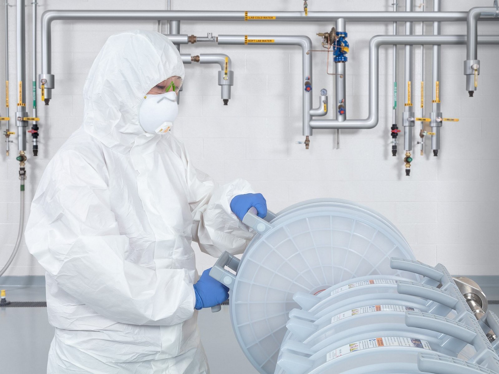 Bioprocessing technician loading capsules into holder