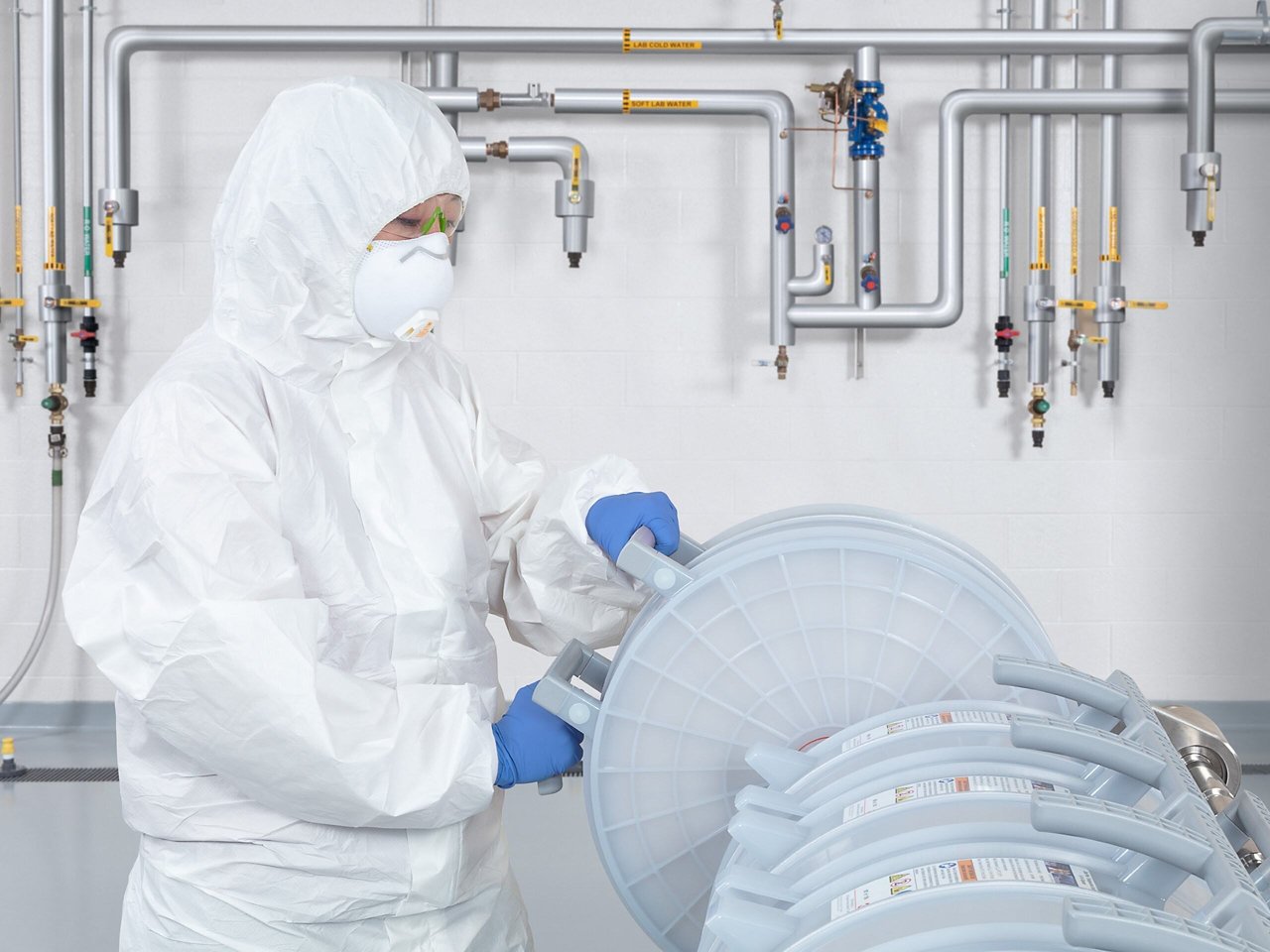 Bioprocessing technician loading capsules into holder