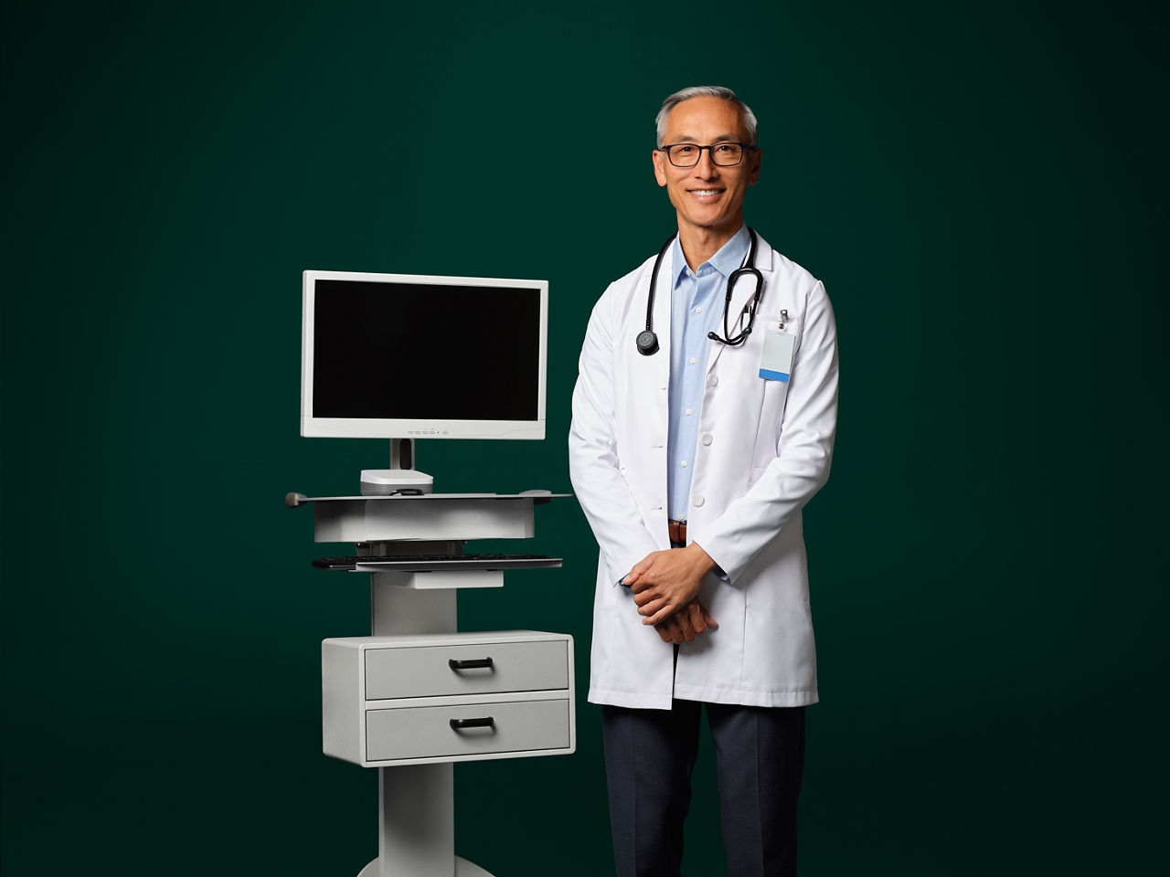 Photo of a doctor standing next to an ambient device