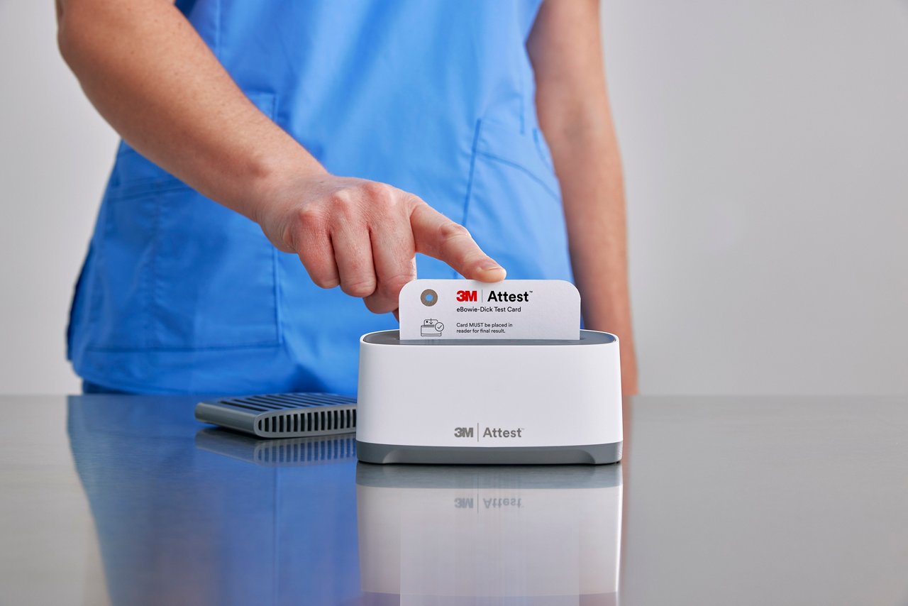 Clinician inserting 3M™ Attest™ eBowie Dick Test Card into the Auto-reader