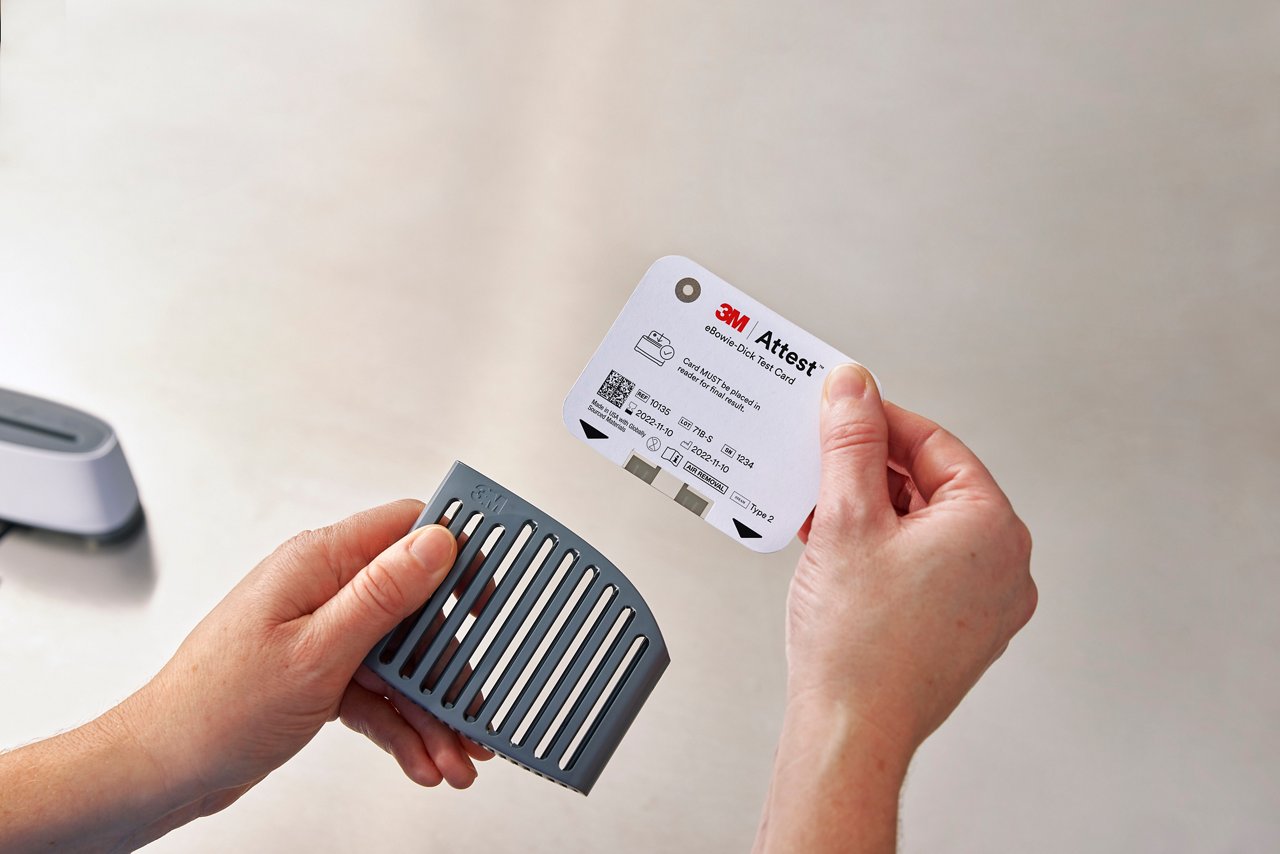 Clinician removing 3M™ Attest™ eBowie-Dick Test card from card holder, birds eye view