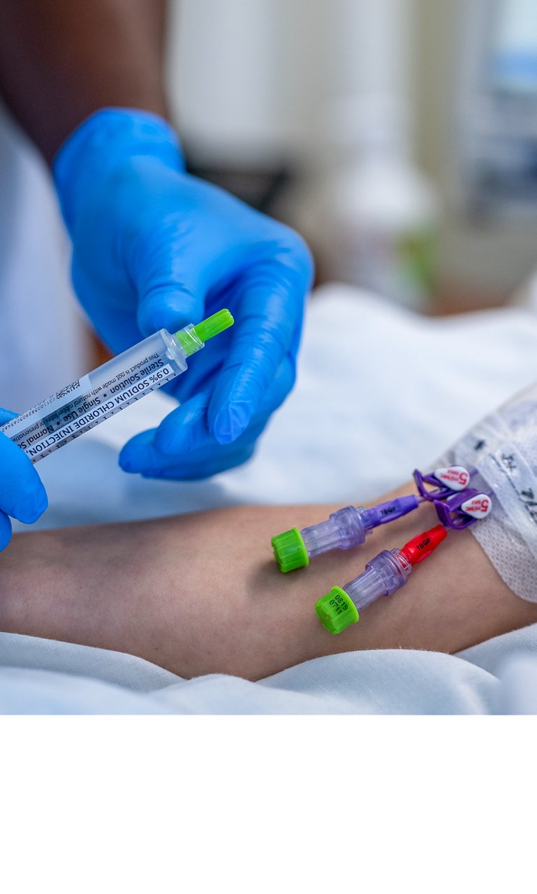 Curos caps for the Clinician hosting a line with Curos™ Tips with a patient with a PICC line capped by