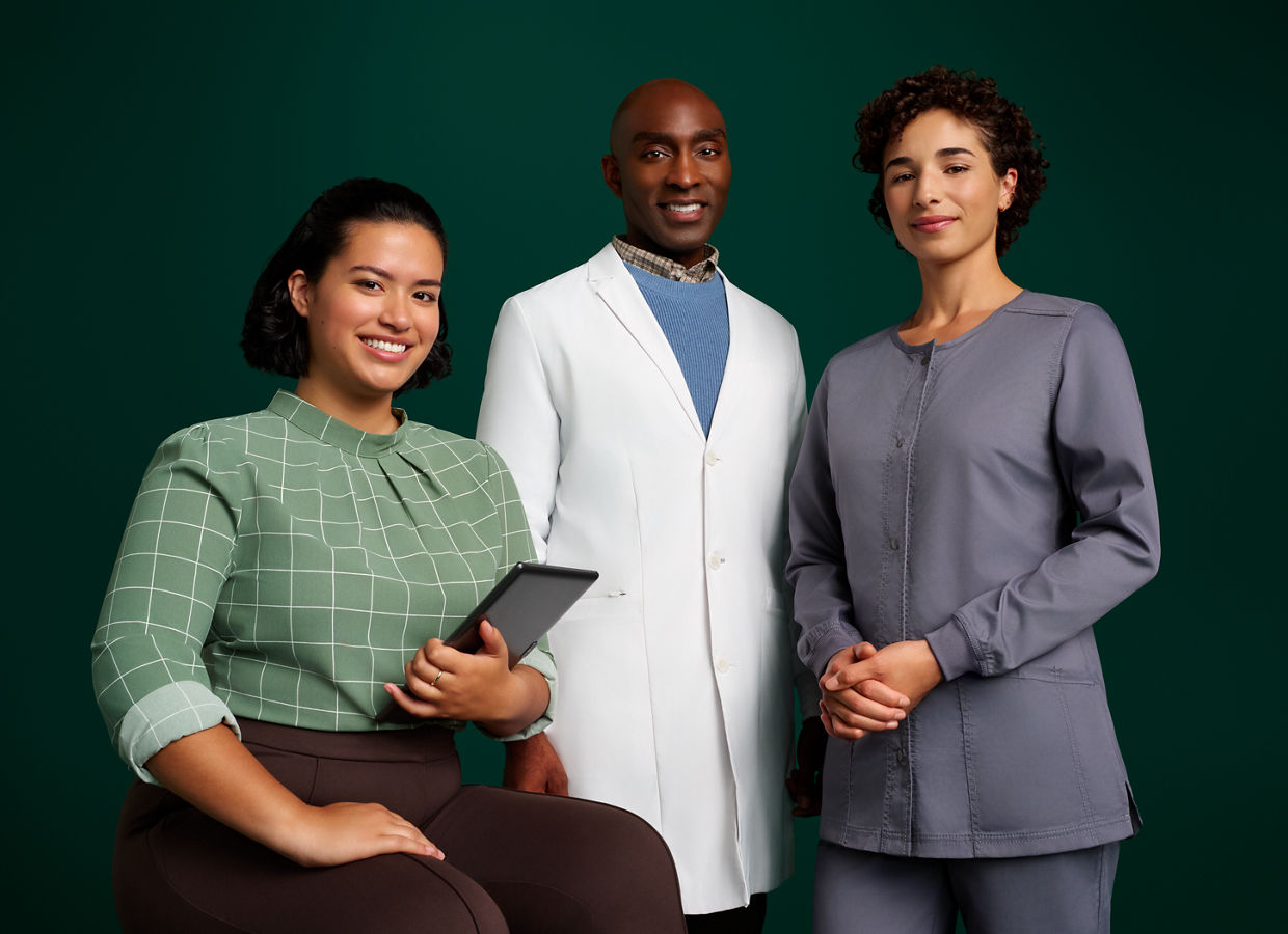 Group portrait of a team of three orthodontic professionals on a dark green background.