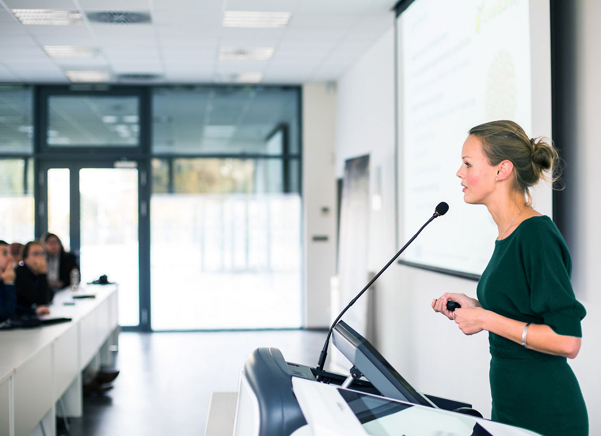 Female instructor presenting in a classroom setting.