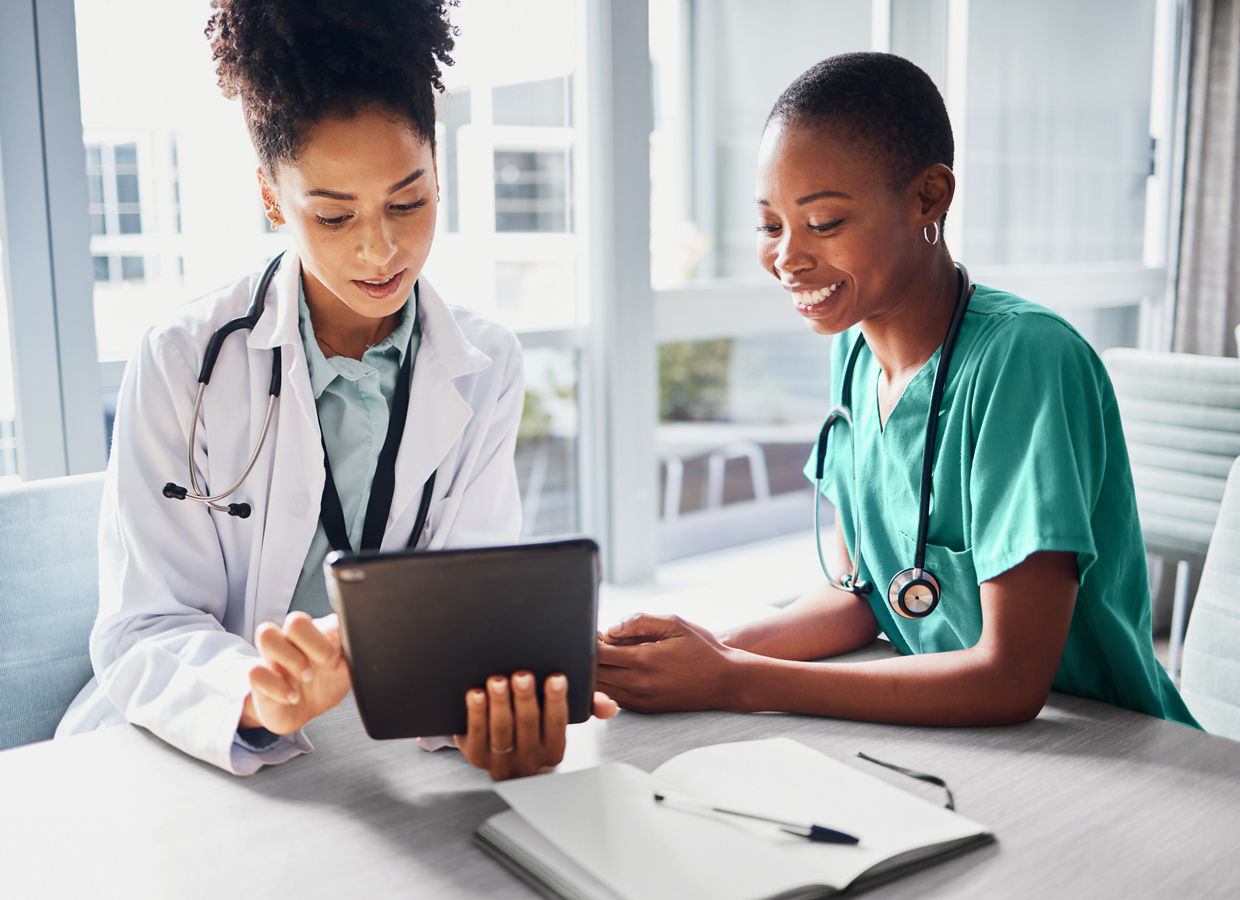 Tablet, black woman or doctors with medical research reading news or tests results in hospital together. Teamwork, digital tech or African nurses planning or speaking of healthcare report on website