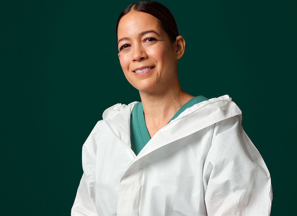 Manufacturing professional wearing a white cleanroom suit.