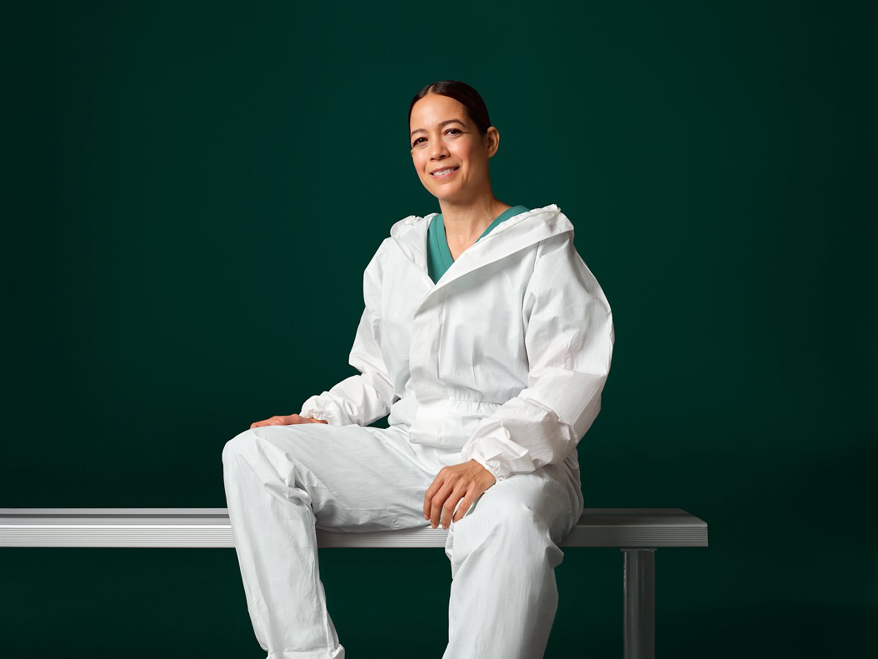 Production specialist wearing white overalls