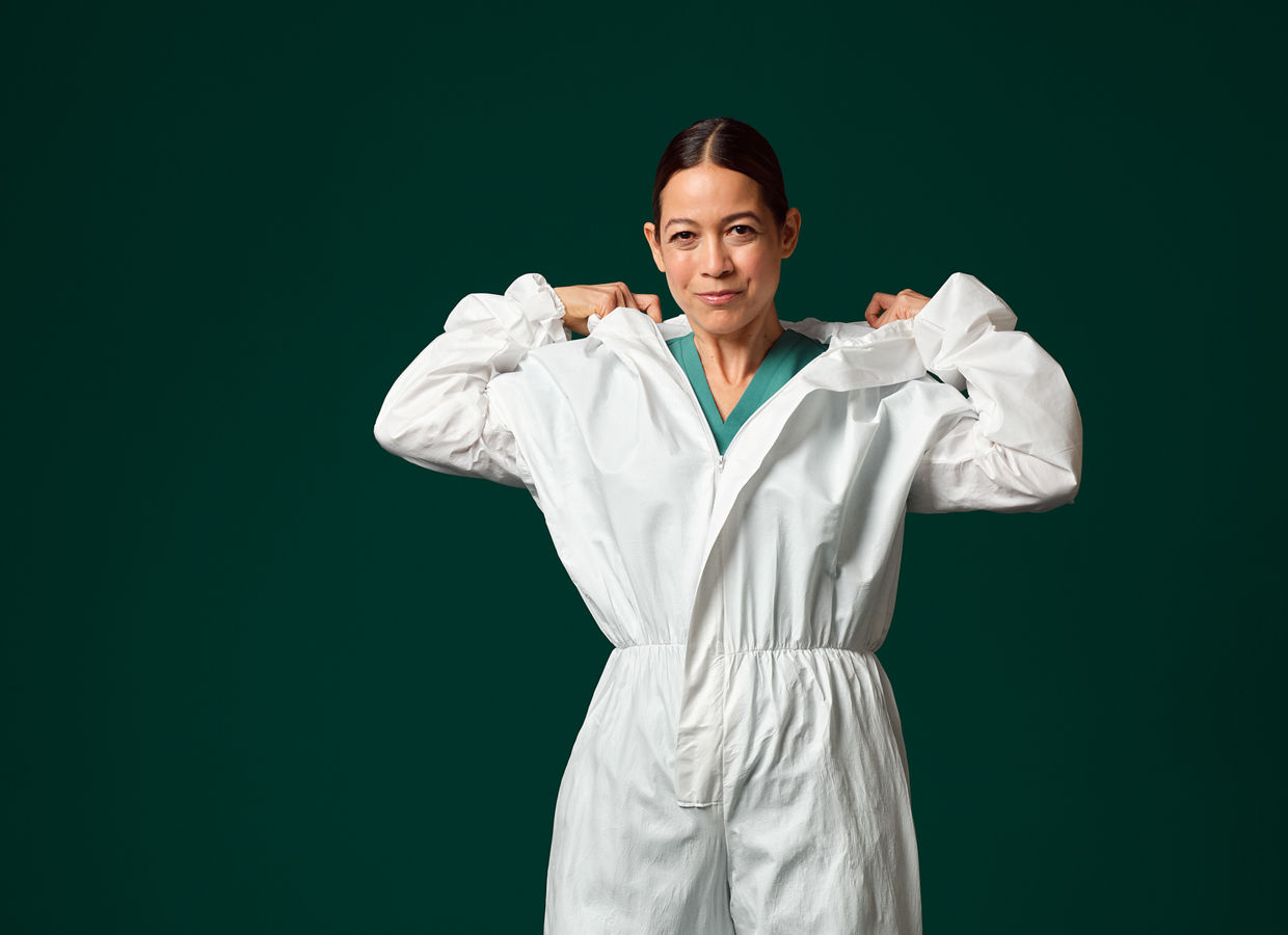 Manufacturing professional wearing a white cleanroom suit.