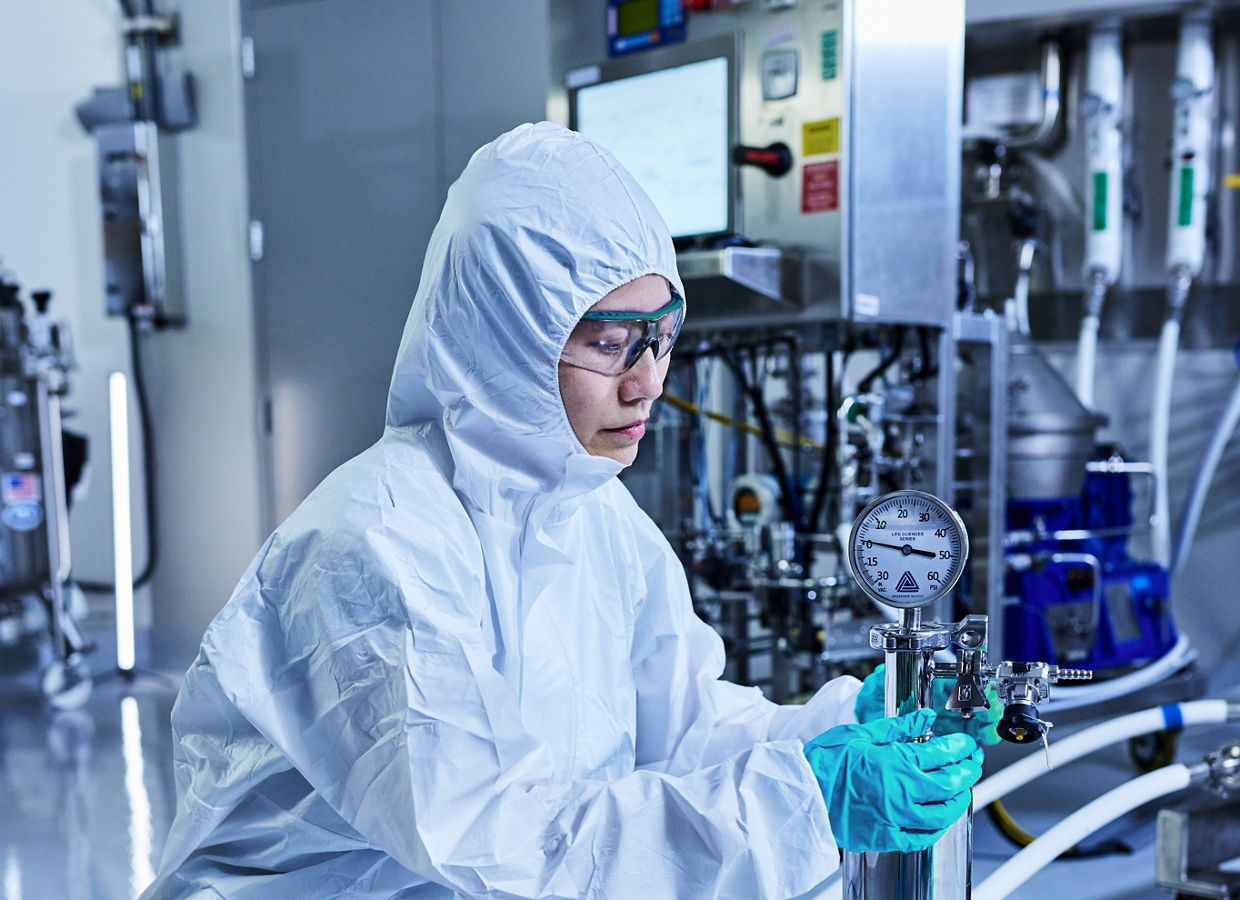 Technician adjusts pressure gauge on sterile housing