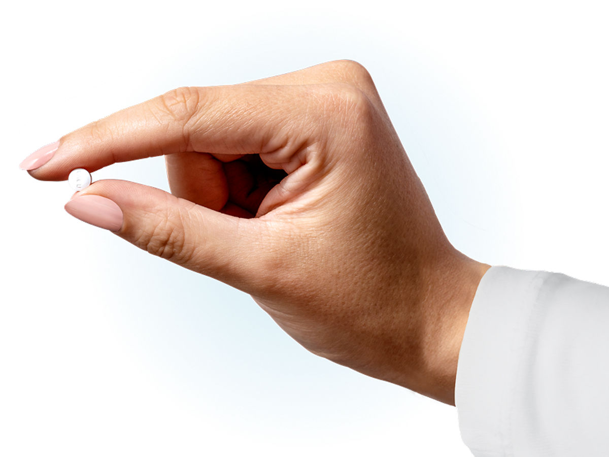 Hand holding a Wegovy<sup>®</sup> pill