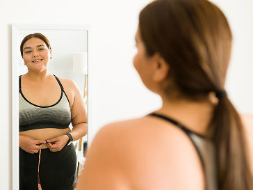Woman smiling at herself in the mirror