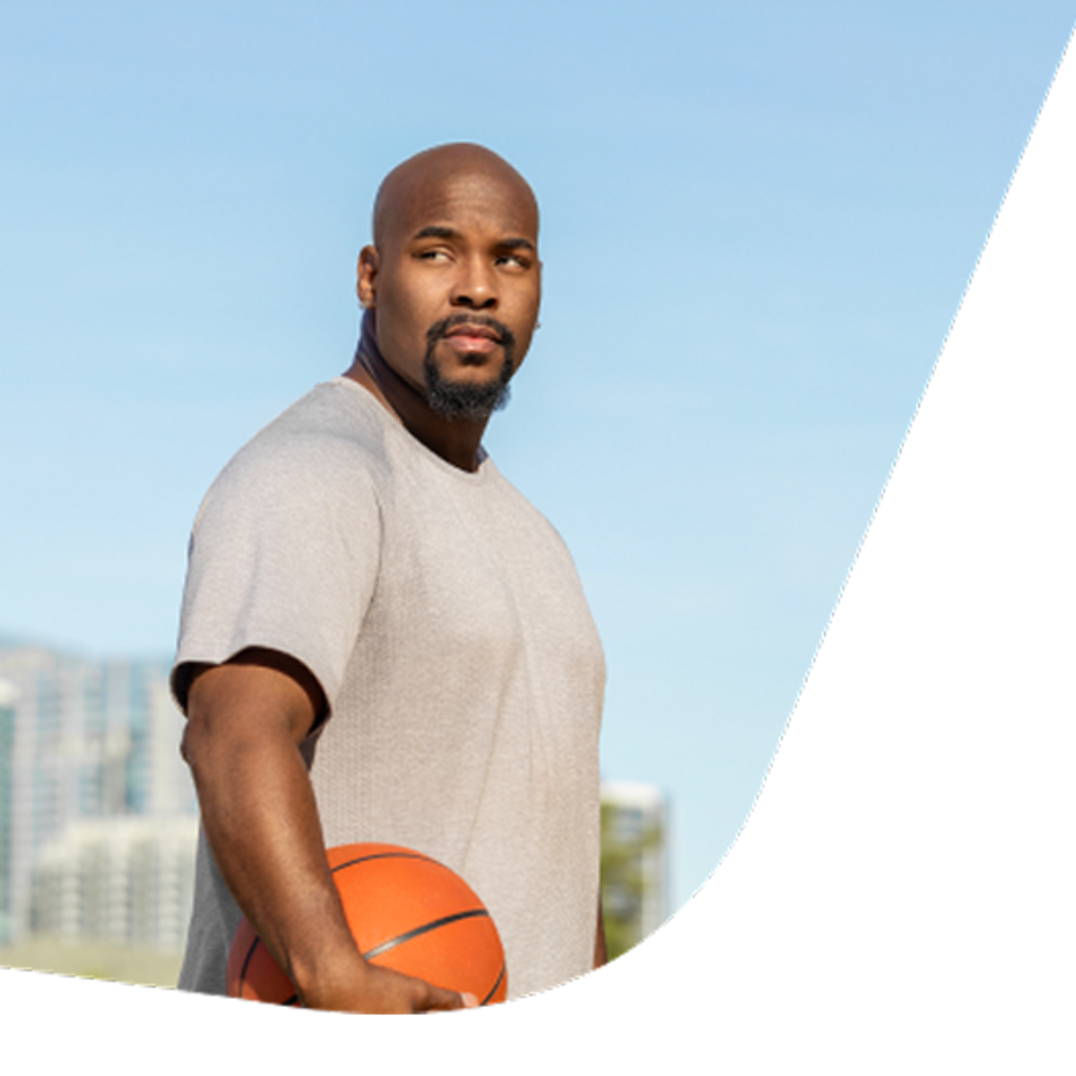 Man standing outside and holding a basketball