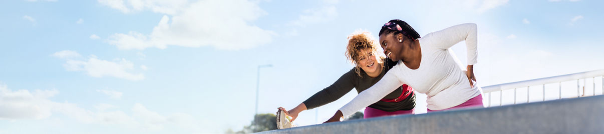 Two women stretching before a workout