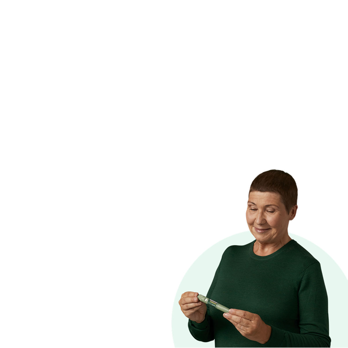 Woman holding and looking down at an Awiqli® FlexTouch® pen