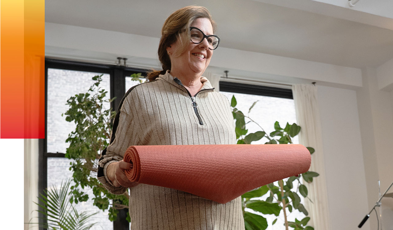 Jane holding a yoga mat