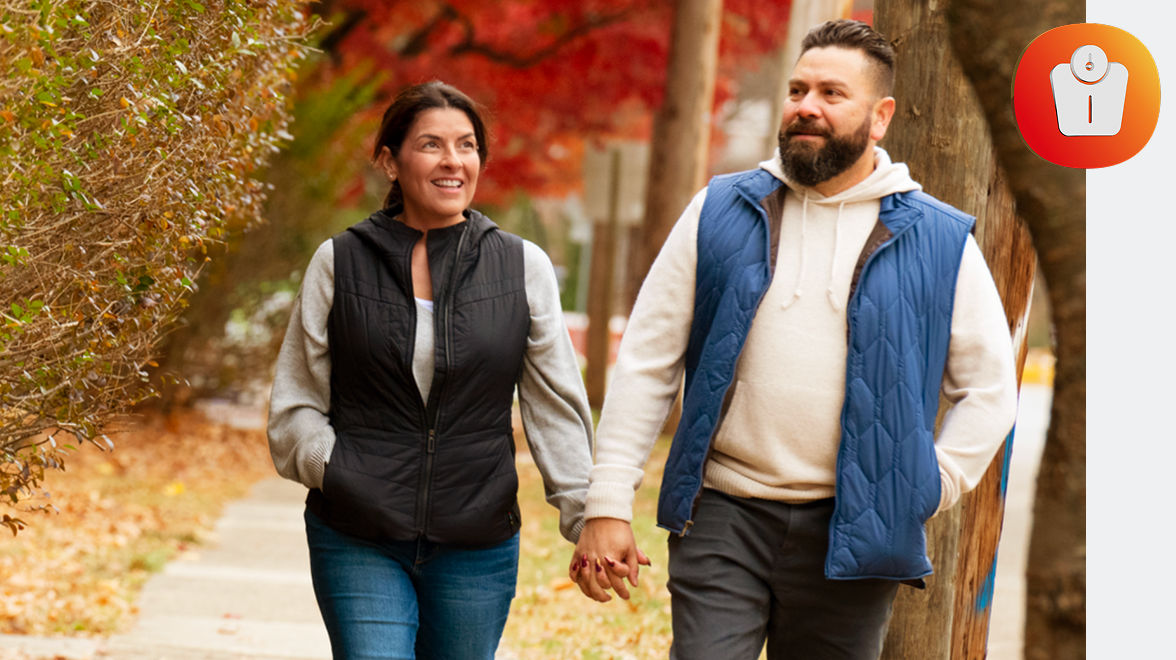 Maria and partner walking and holding hands with a scale icon to the right