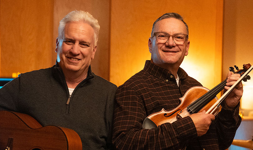 Mike and Tom holding instruments