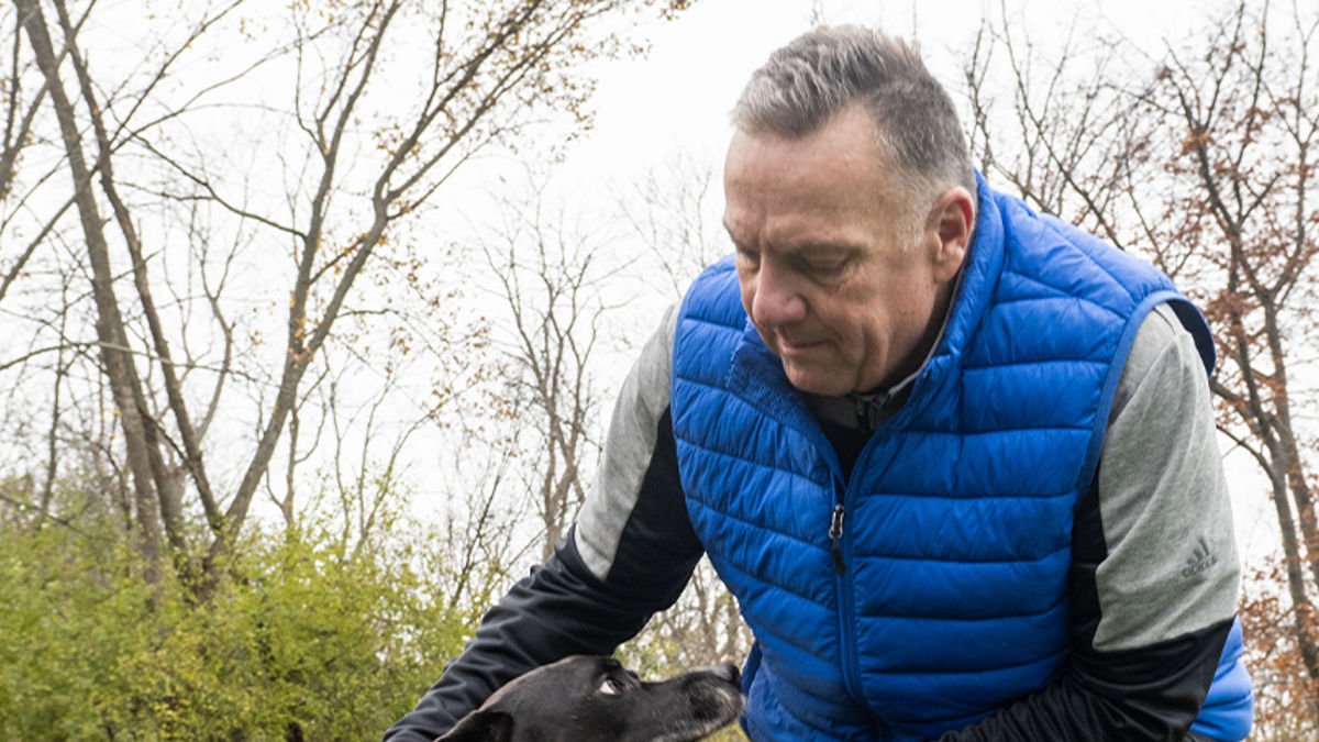 Mike walking outside with his dog