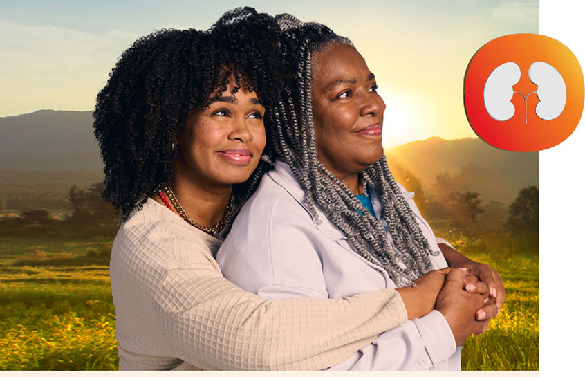 Two women hugging and smiling with a kidney icon to the right