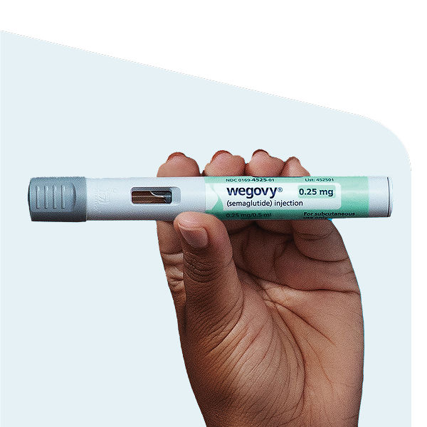 Hand holding wegovy pen