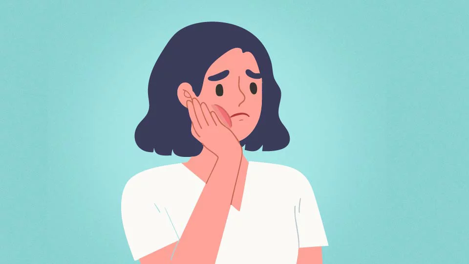 Girl holding her cheek due to a toothache