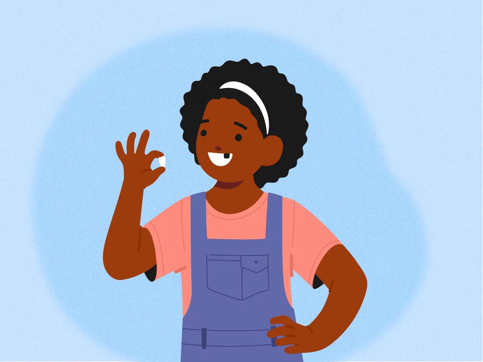 Child smiling with missing tooth in hand