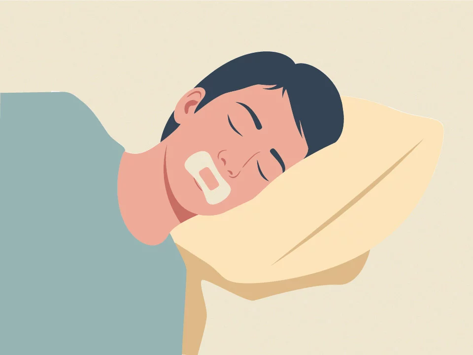 man sleeping on pillow with mouth tape
