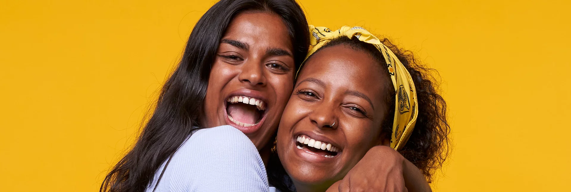Two women smiling and hugging