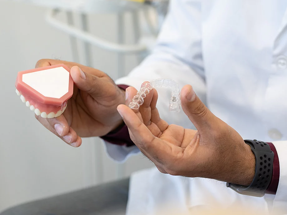 Dentist holding clear aligner