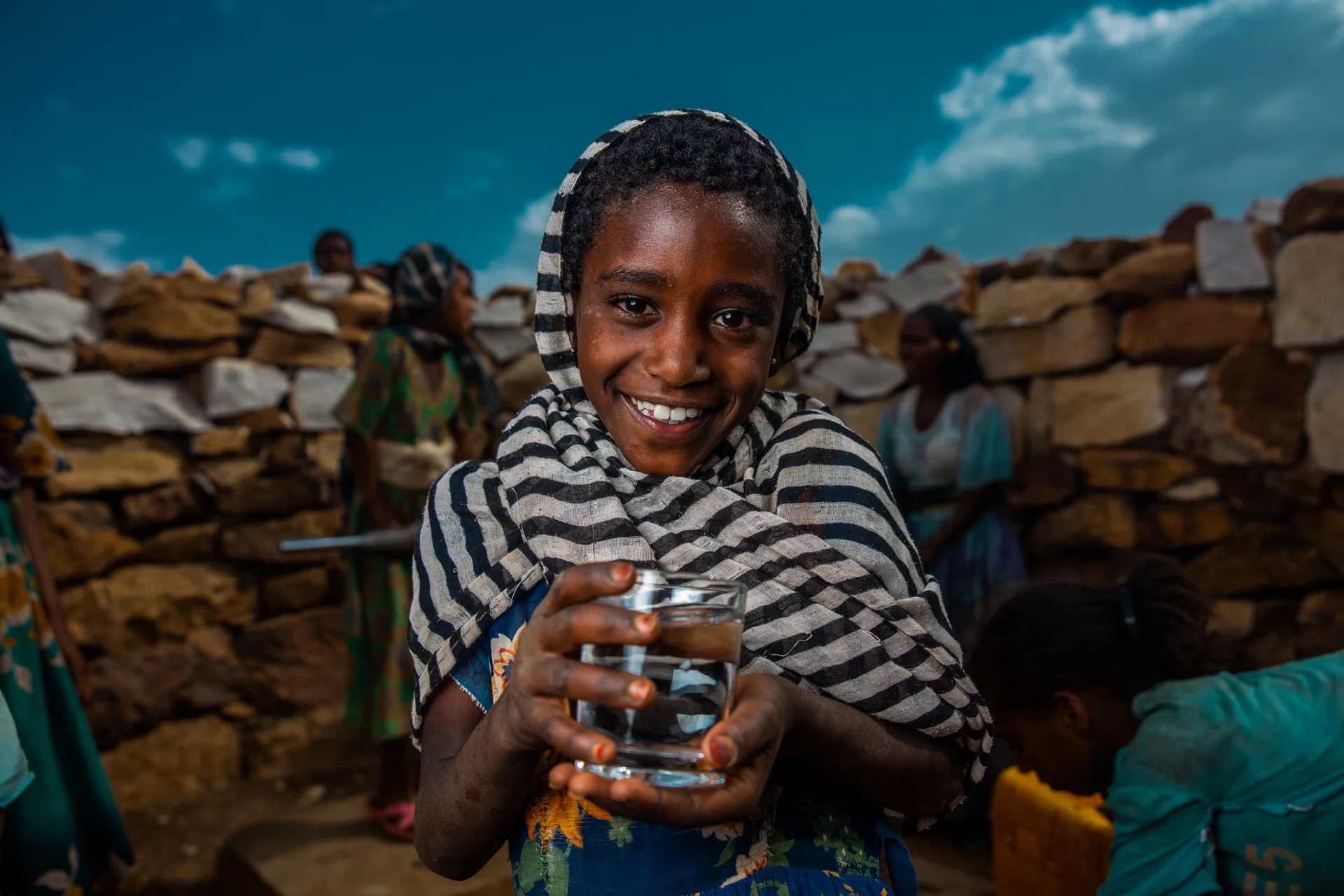 Image of a kid holding clean drinking water in Ethiopia