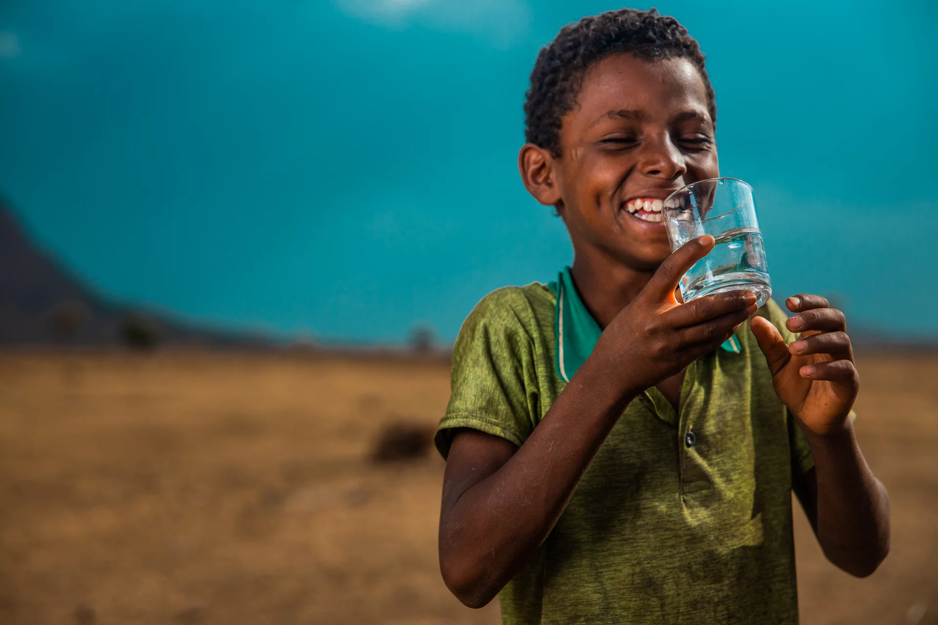 Image of a Boy in Ethiopia drinking clean water from charity:water