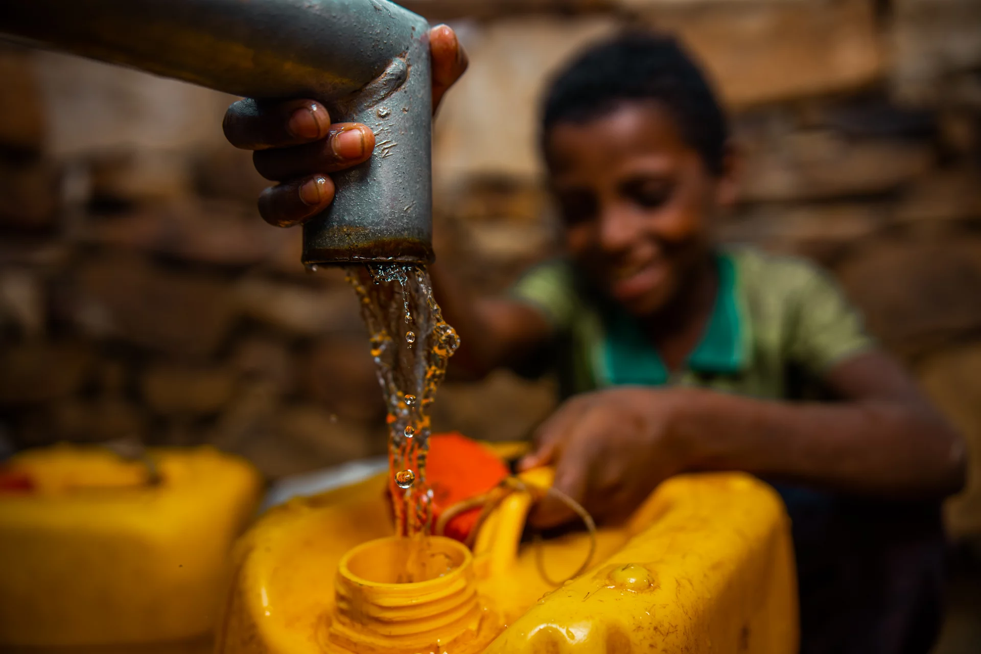 Image of a child getting clean water in Ethiopia