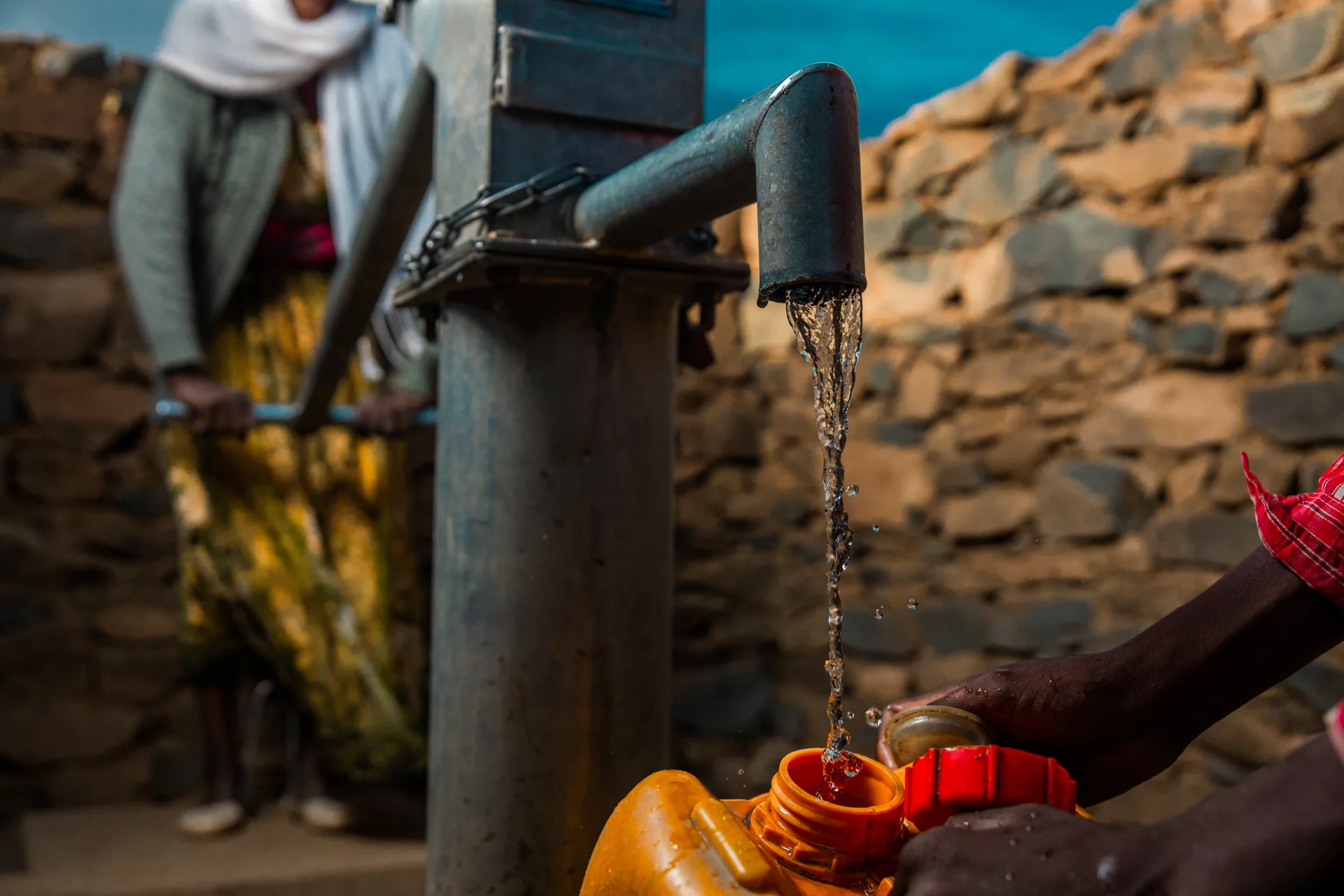 Image of child filling canteen with clean drinking water in Ethiopia