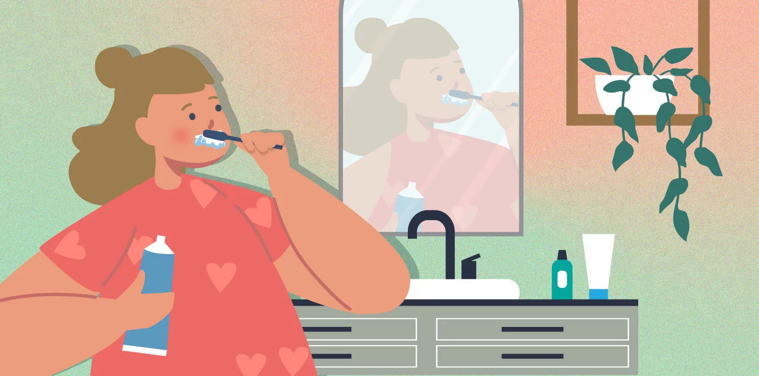 Girl wearing heart shirt brushing her teeth