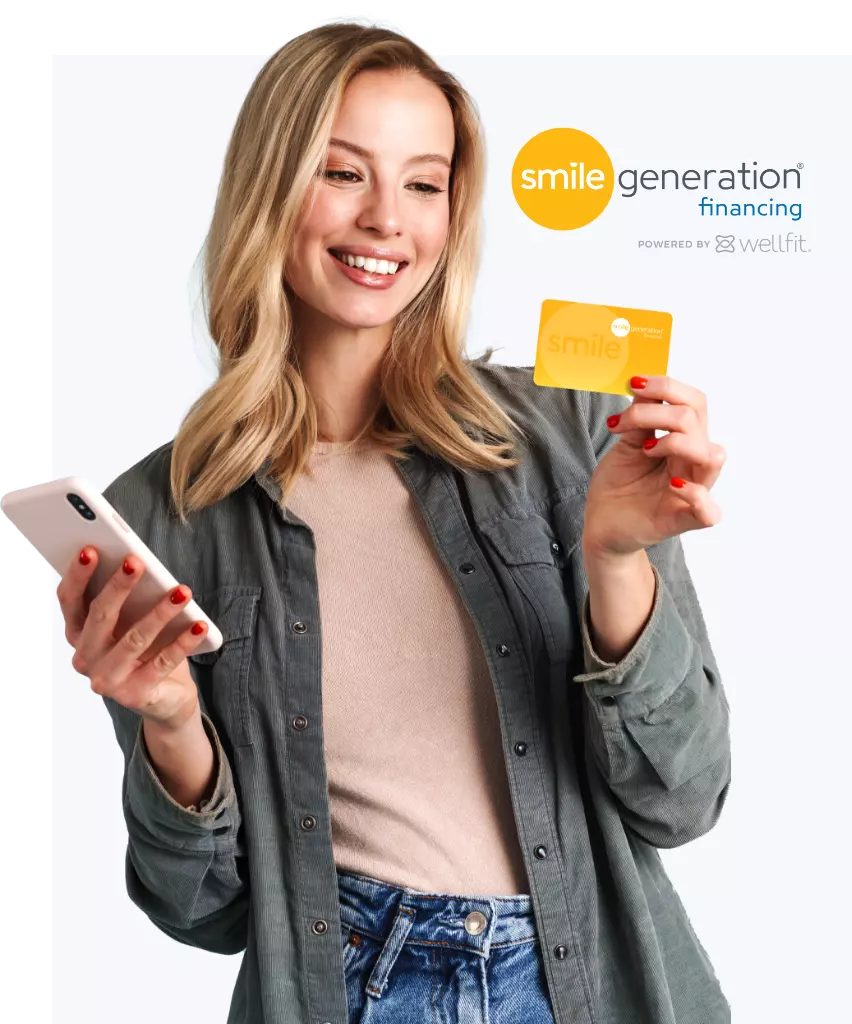 Image of female holding Smile Generation Credit Card part of Smile Generation Financing