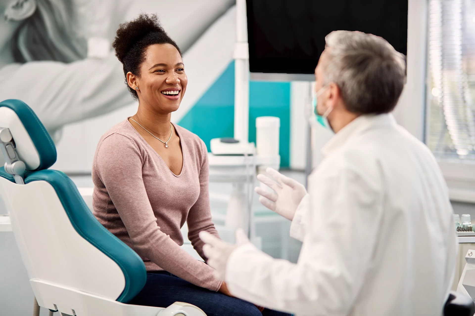 a dental patient speaking with her dentist about her oral health