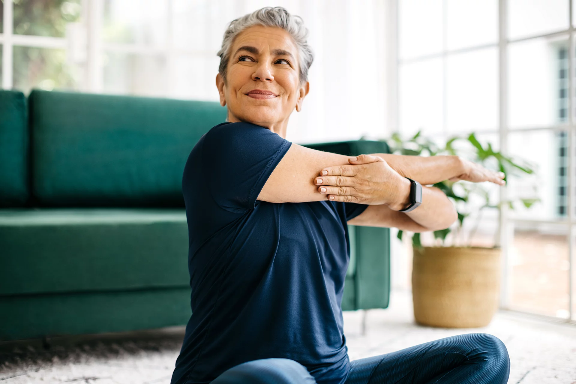Older woman stretching arms with smile