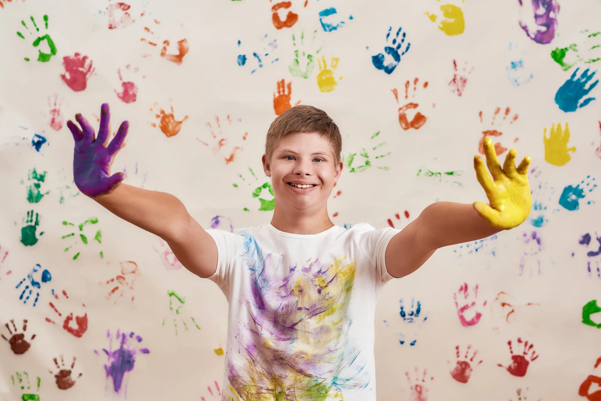 young boy with paint on his hands