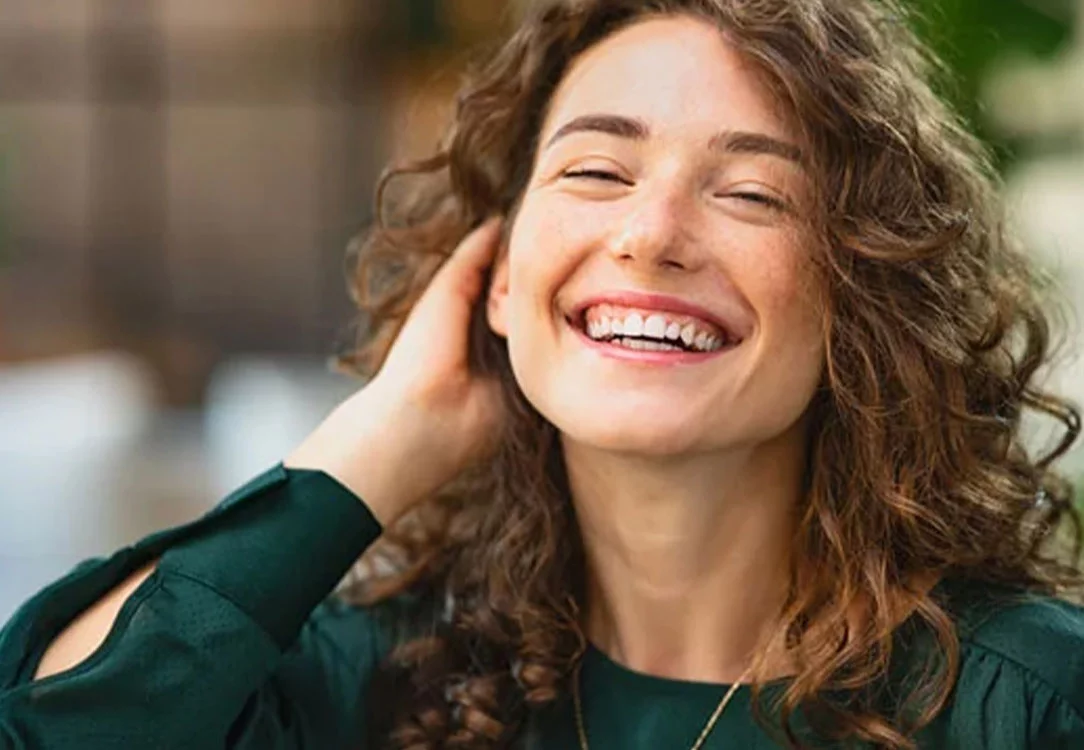 Woman with curly hair smiling 