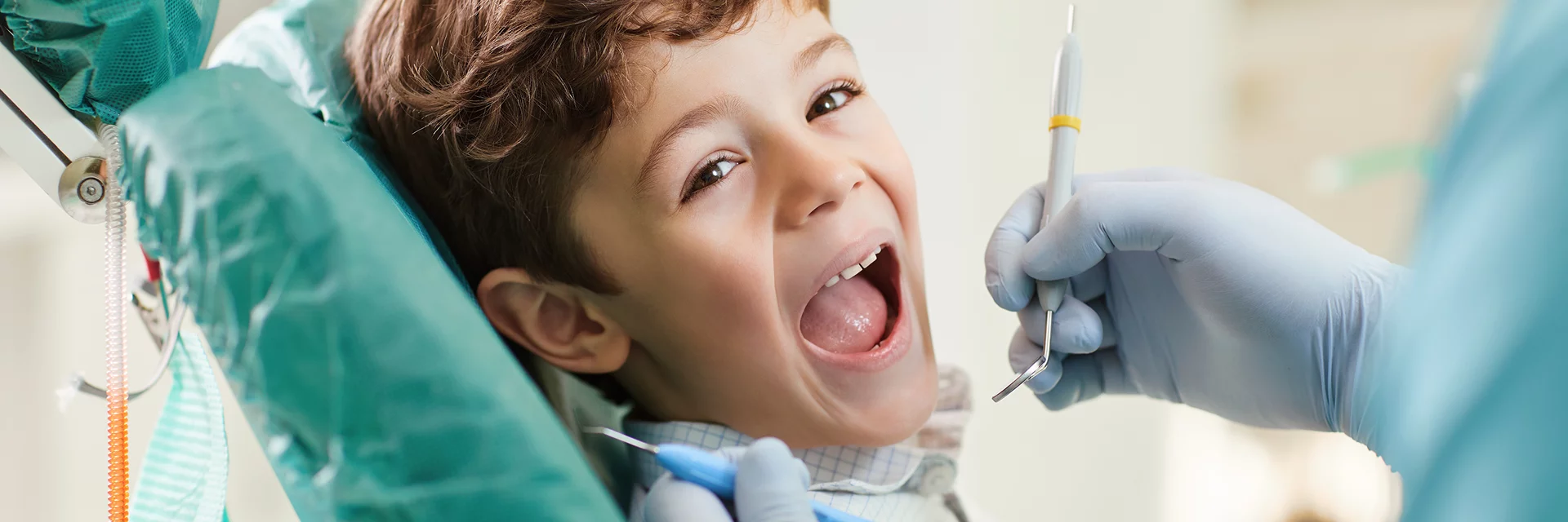 Boy getting his teeth checked by dentist